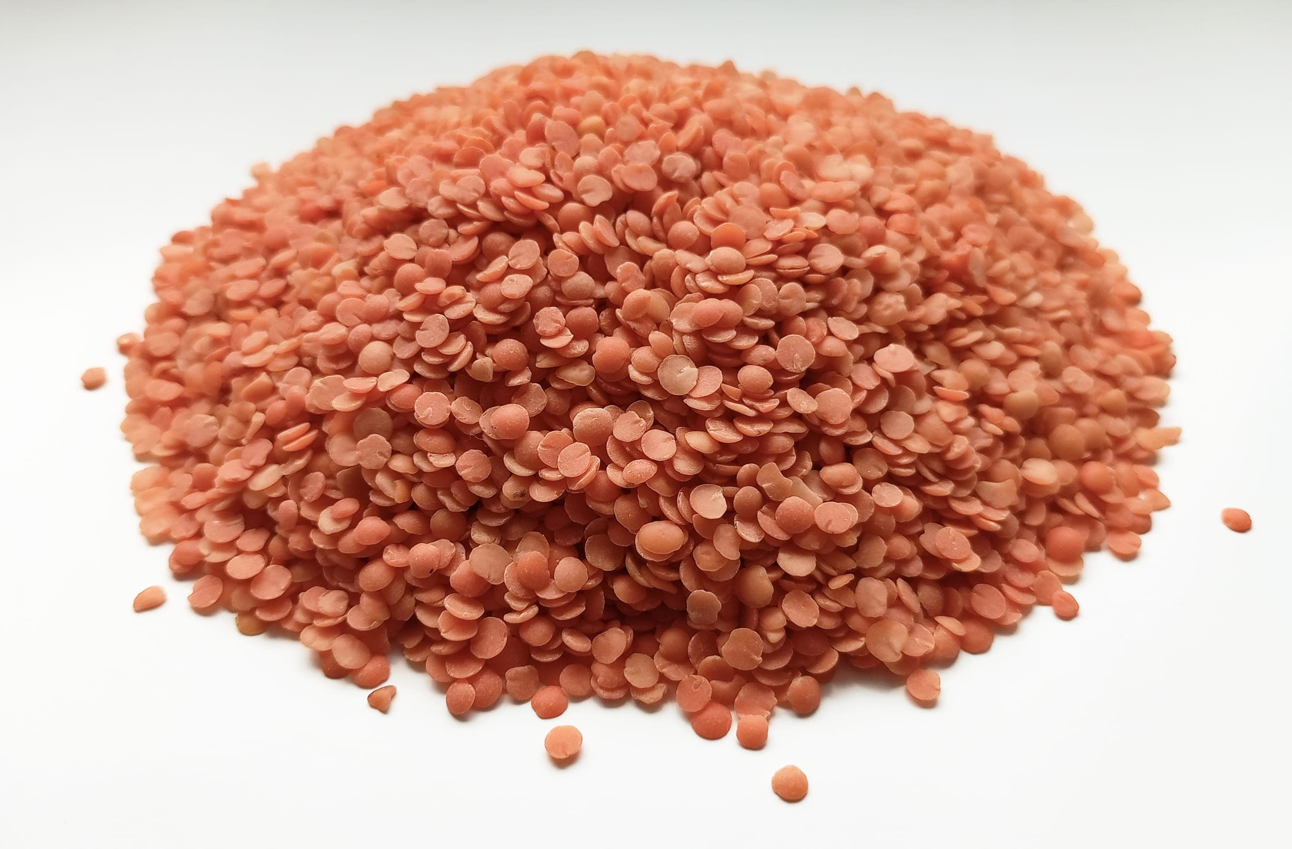 A pile of dried split red lentils